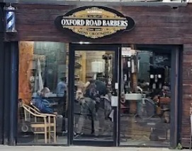 The Oxford Road Barbers shop front on Oxford Street, with the striped pole beside the door